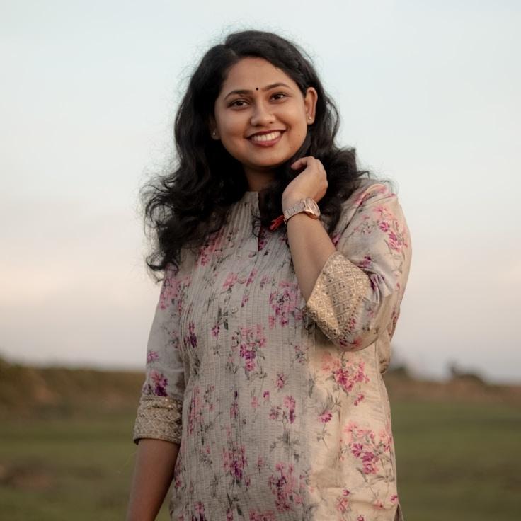 Kaveri Mehta, Lead Design Curator at Braveloft Studio, reviewing corporate floral arrangements